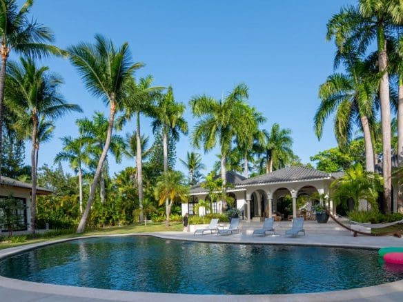 buyDRproperty Stunning Villa SUNSET with pool, palm trees, and clear blue sky in Sea Horse Ranch. Sosua Real Estate