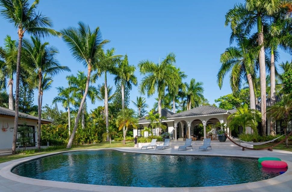 buyDRproperty Stunning Villa SUNSET with pool, palm trees, and clear blue sky in Sea Horse Ranch. Sosua Real Estate
