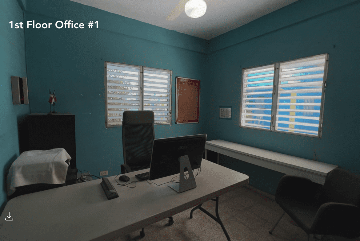 buyDRproperty Office space for a hostel business with windows and a desk. Sosua Real Estate