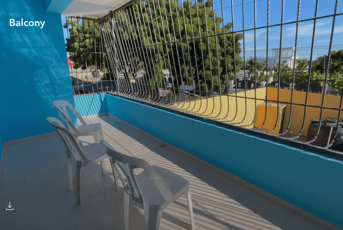 buyDRproperty Balcony of a hostel business in Monti Cristi with white chairs and a view. Sosua Real Estate