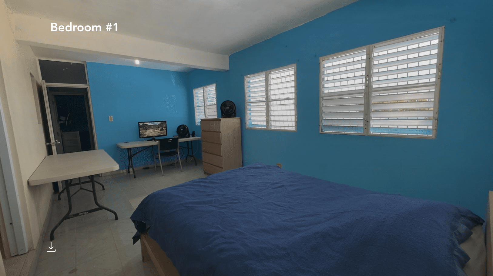 buyDRproperty Bedroom in a hostel business with a bed, desk, and windows. Sosua Real Estate