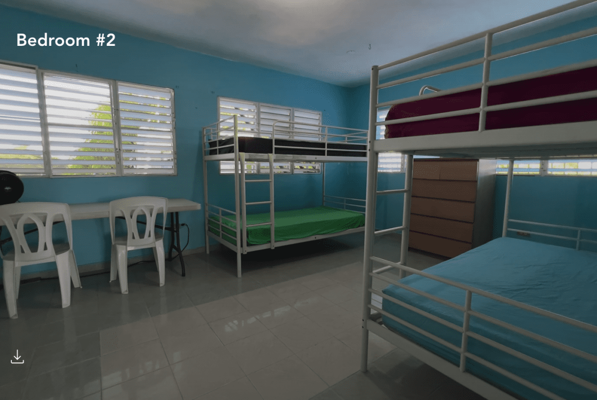 buyDRproperty Bedroom #2 at a hostel business with bunk beds and windows. Sosua Real Estate