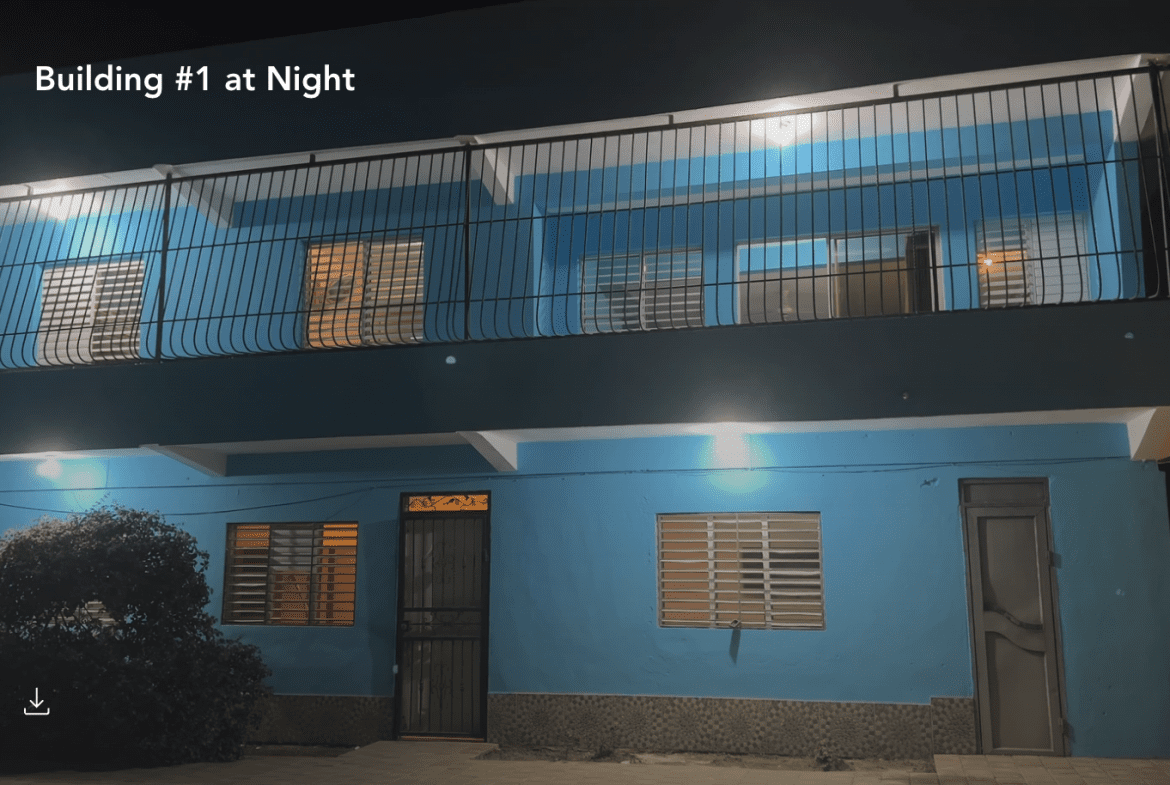 buyDRproperty Blue building at night in Monti Cristi, potentially a hostel business. Sosua Real Estate