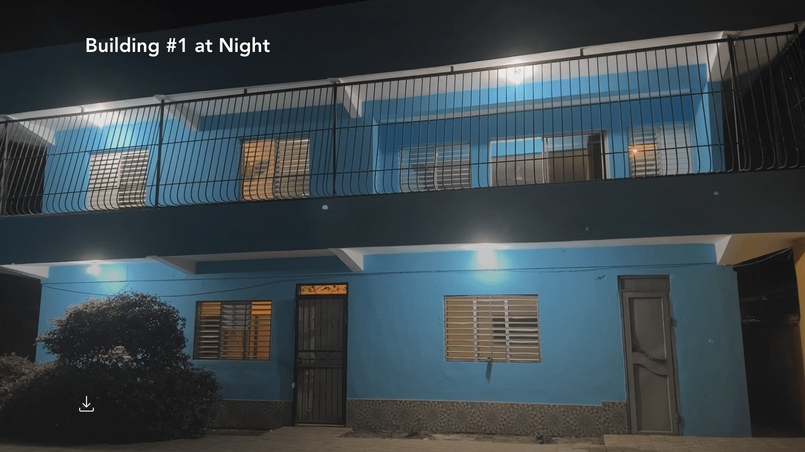 buyDRproperty Blue building at night in Monti Cristi, potentially a hostel business. Sosua Real Estate
