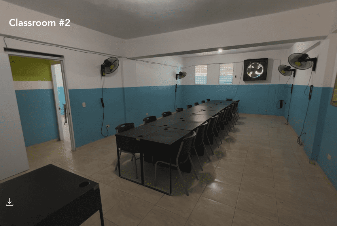 buyDRproperty Classroom in a Hostel Business for sale with long table and chairs. Sosua Real Estate