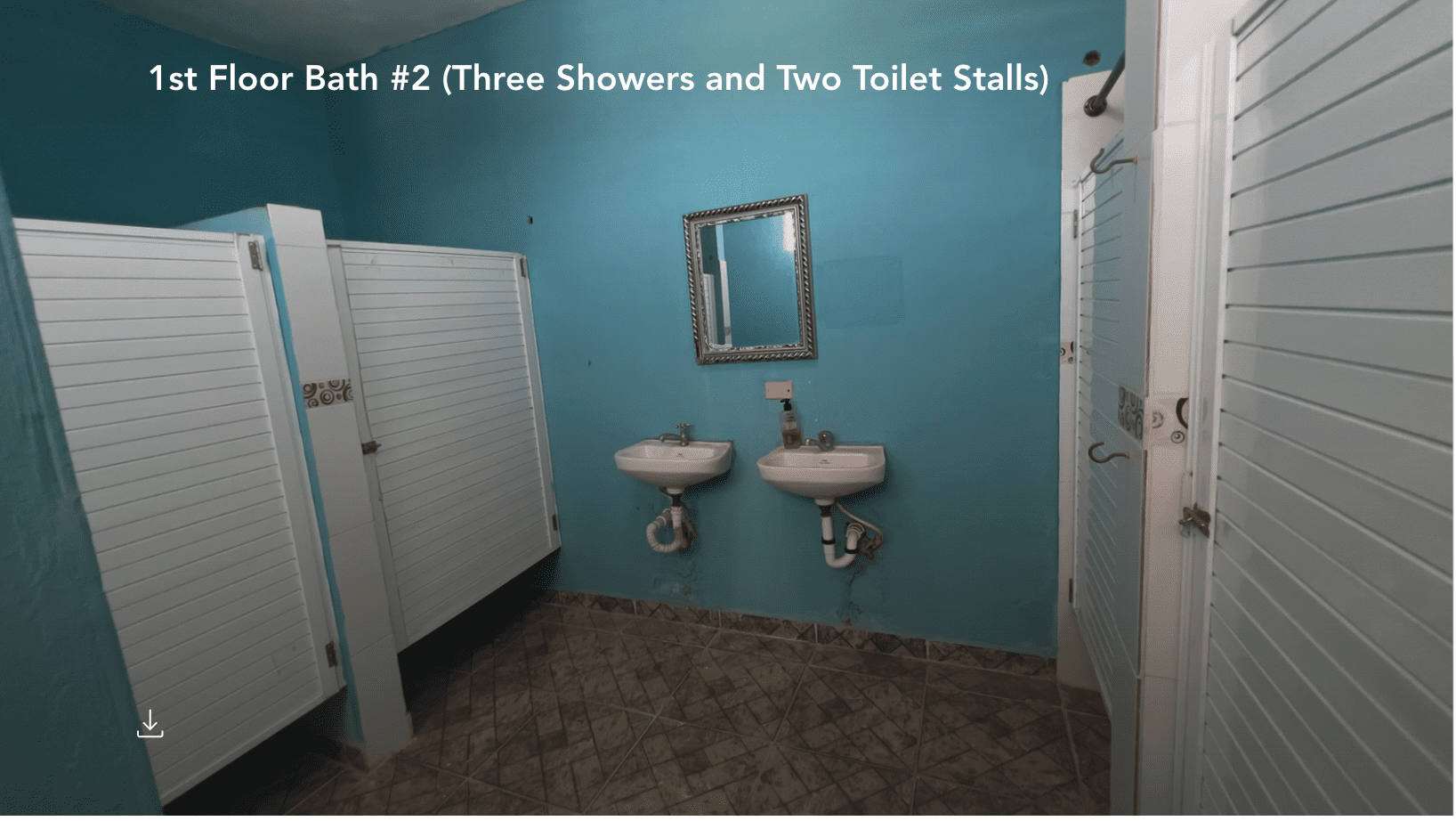 buyDRproperty Public bathroom with three stalls and two sinks, possibly part of a Hostel Business. Sosua Real Estate