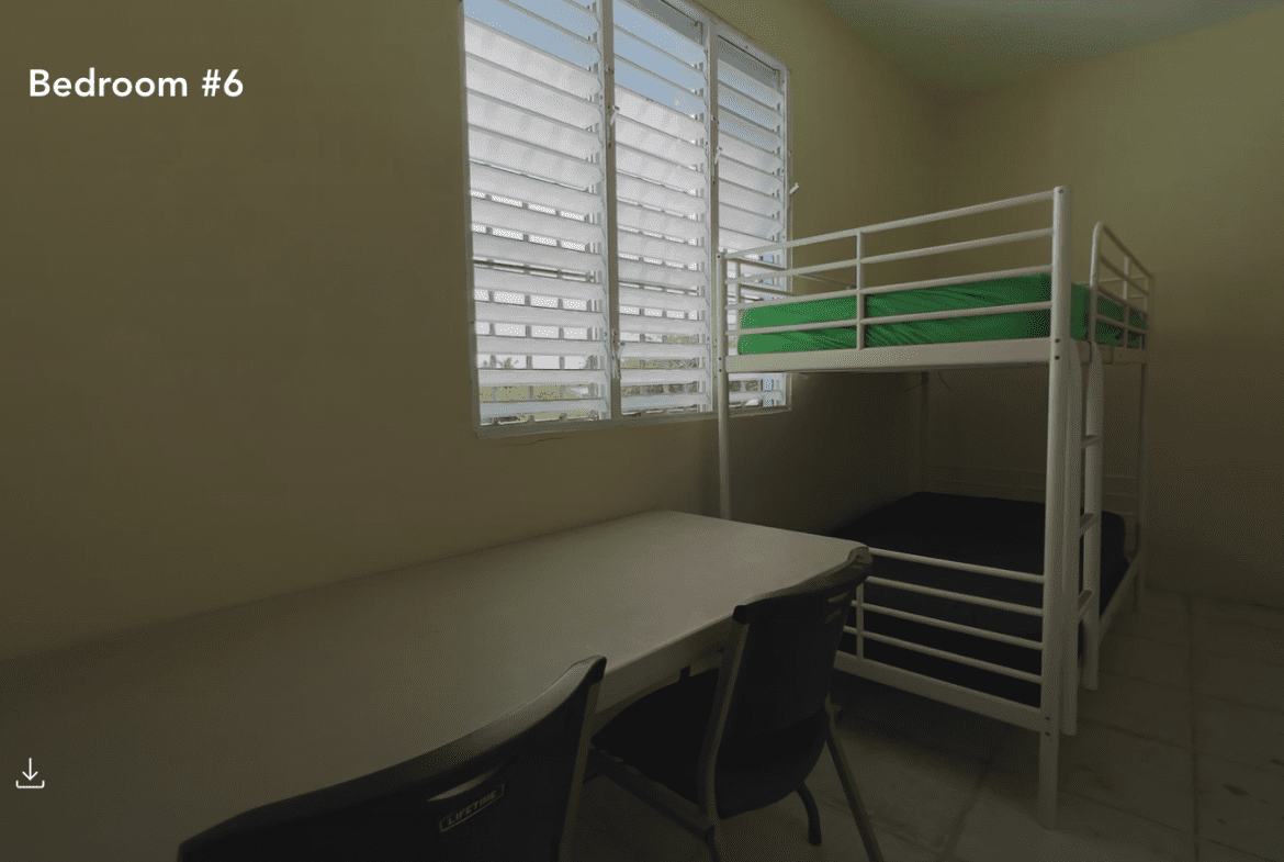 buyDRproperty Bedroom #6 in a hostel with bunk beds, desk, and window. Hostel business for sale. Sosua Real Estate