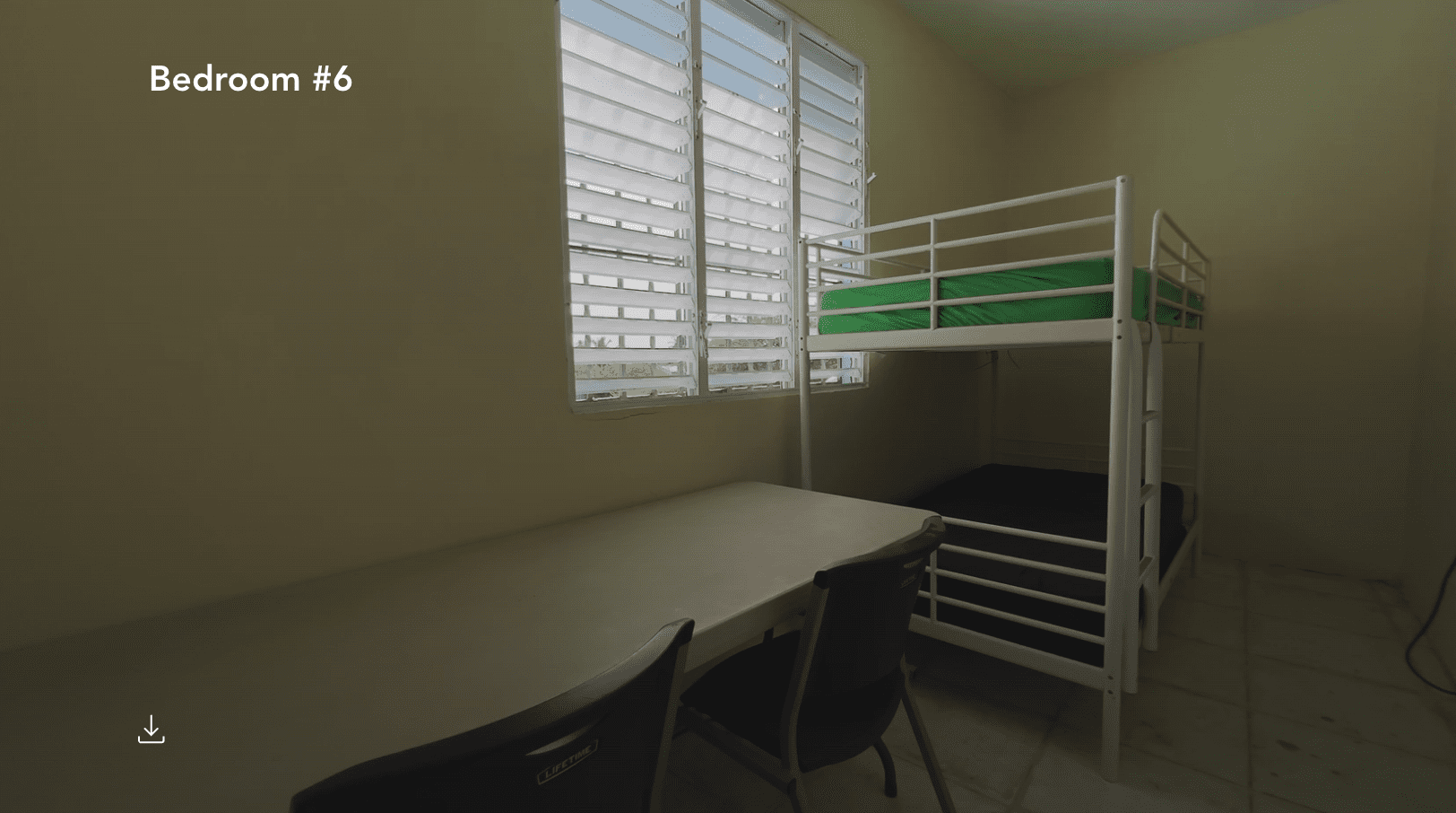 buyDRproperty Bedroom #6 in a hostel with bunk beds, desk, and window. Hostel business for sale. Sosua Real Estate