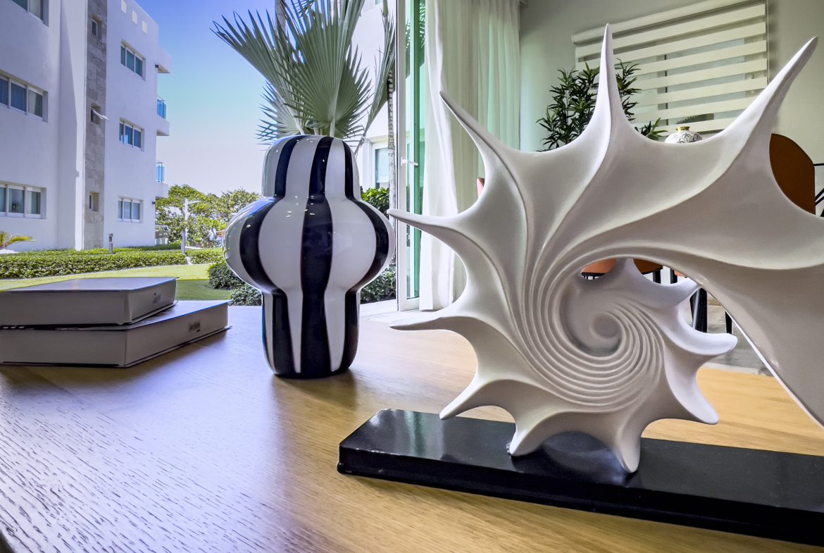 buyDRproperty Modern 3 Bedroom Oceanfront Condo interior with decorative sculpture and view Sosua Real Estate