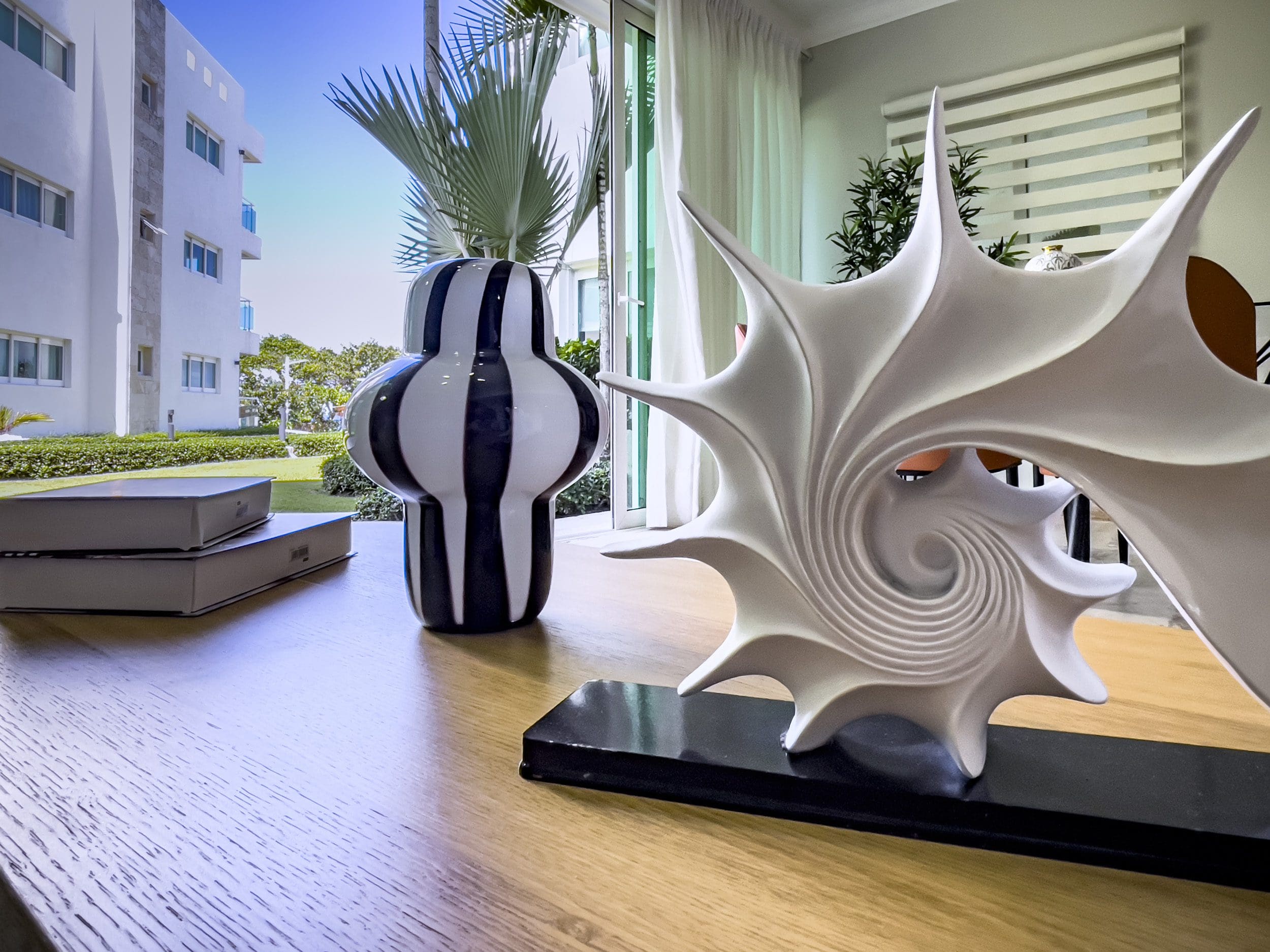 buyDRproperty Modern 3 Bedroom Oceanfront Condo interior with decorative sculpture and view Sosua Real Estate