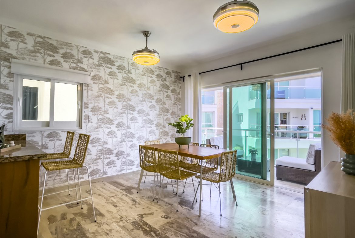 buyDRproperty Dining area in an oceanfront condo for sale. Table and chairs with balcony view. Sosua Real Estate