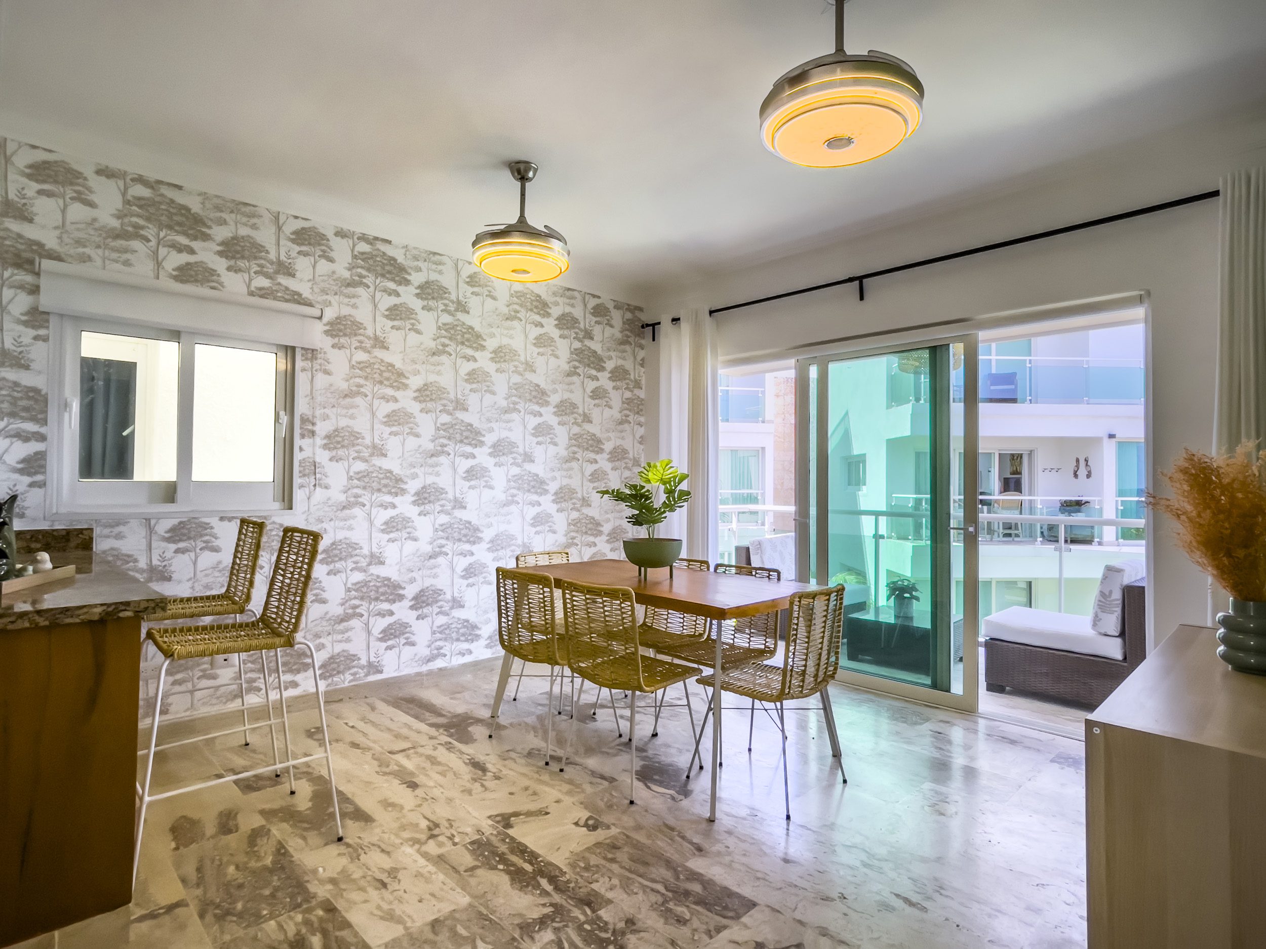 buyDRproperty Dining area in an oceanfront condo for sale. Table and chairs with balcony view. Sosua Real Estate