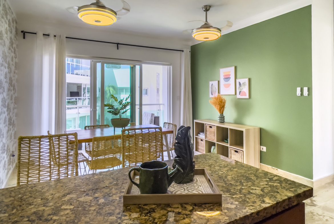buyDRproperty Oceanfront condo for sale: modern kitchen with island and dining area. Sosua Real Estate