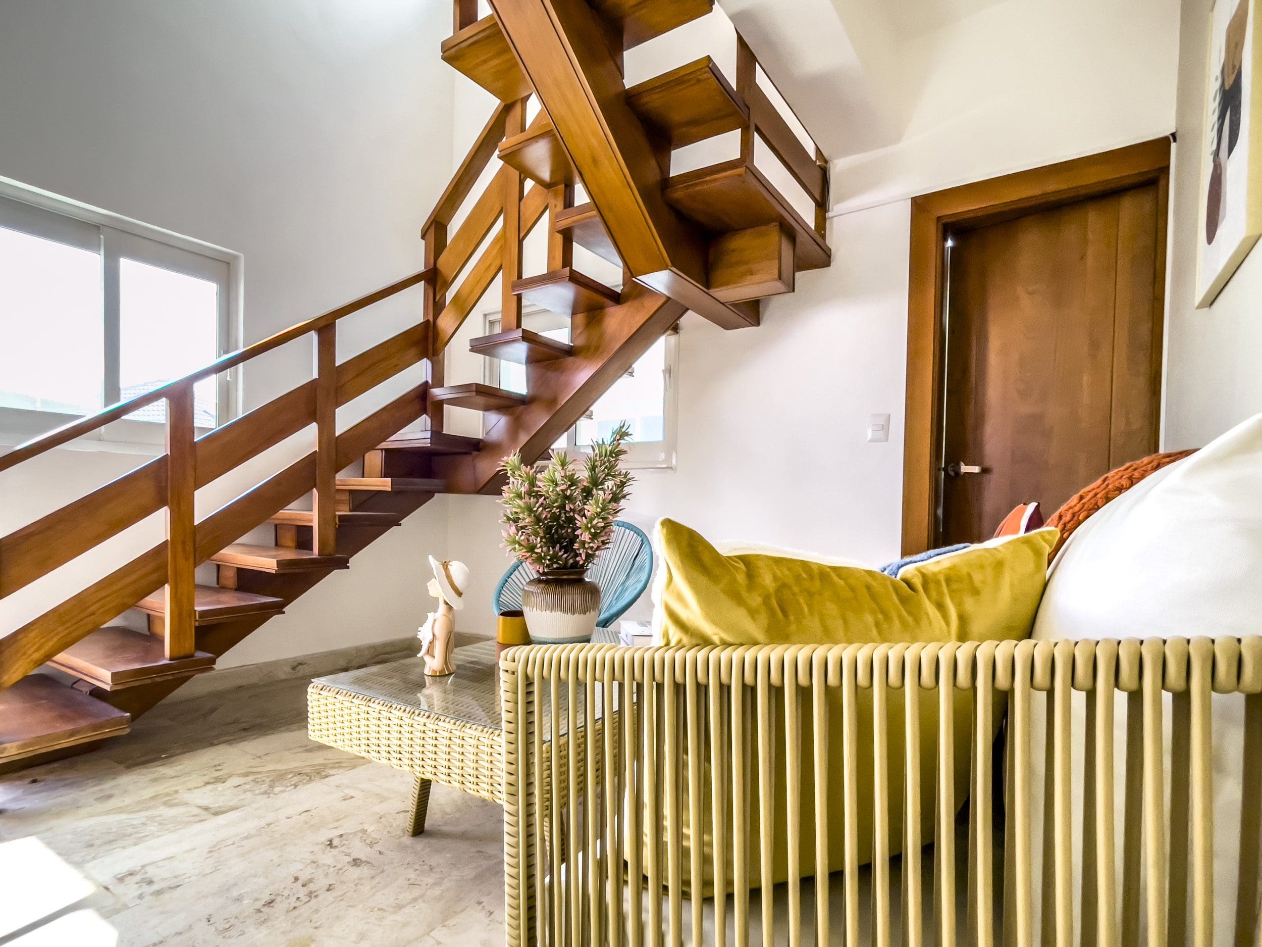 buyDRproperty Interior of oceanfront condo for sale featuring wooden staircase and stylish living room Sosua Real Estate