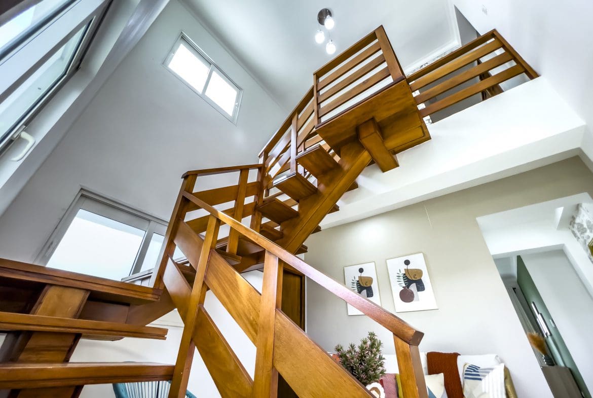 buyDRproperty Wooden staircase in a modern oceanfront condo for sale Sosua Real Estate