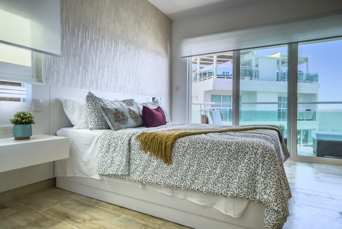 buyDRproperty Modern oceanfront condo bedroom with a view. Sosua Real Estate
