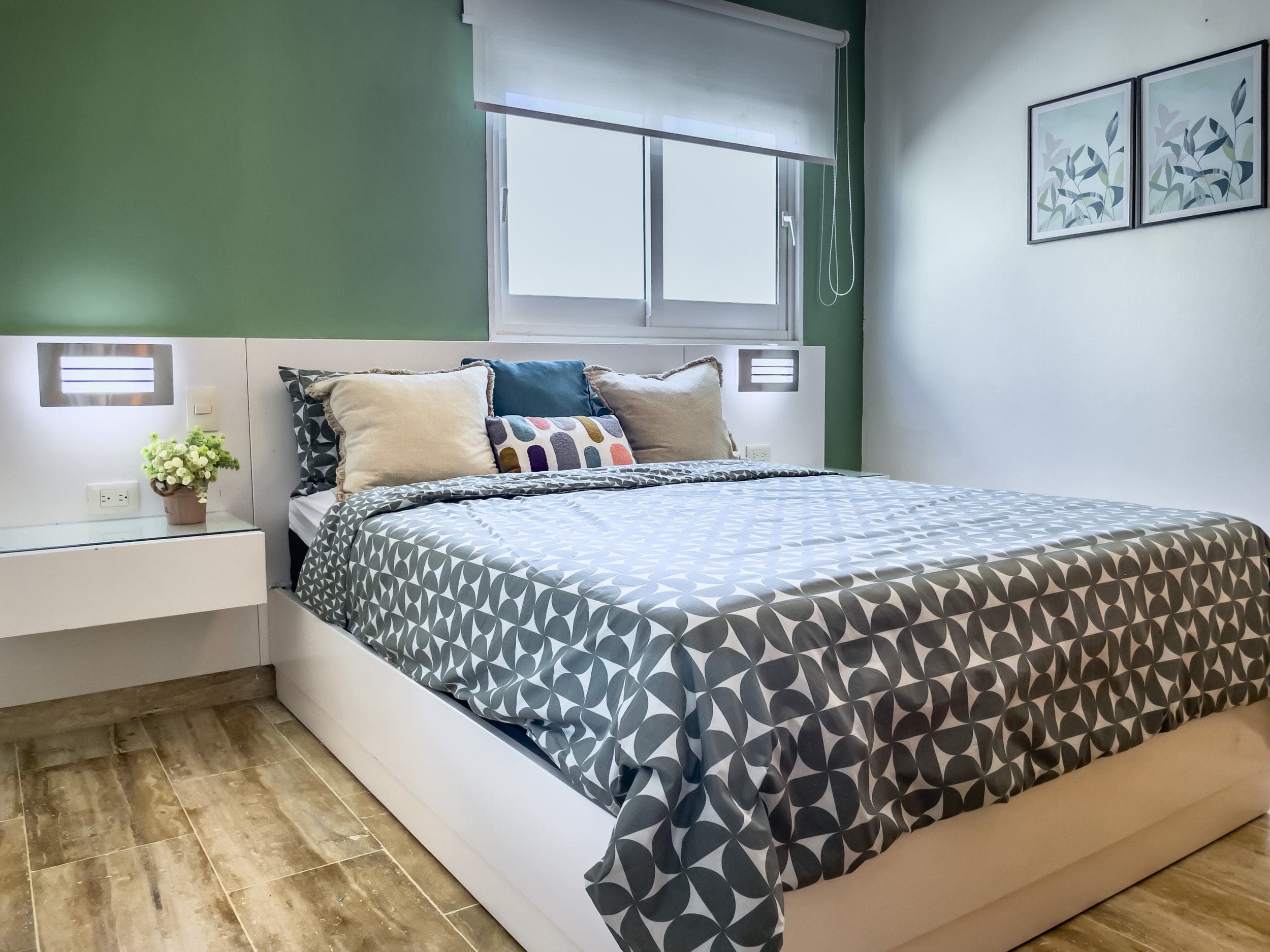 buyDRproperty Modern bedroom with a geometric pattern duvet cover, part of an oceanfront condo for sale. Sosua Real Estate