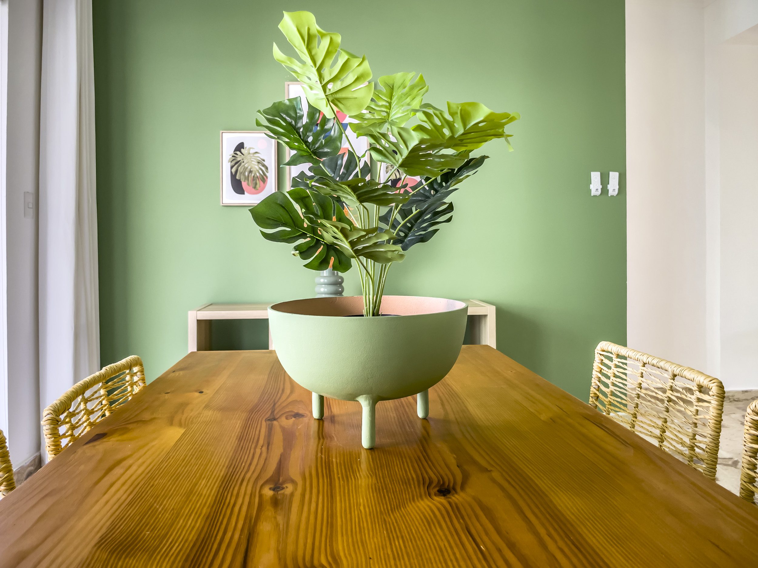 buyDRproperty Dining room table with a large green plant in a Sosua oceanfront condo. Sosua Real Estate