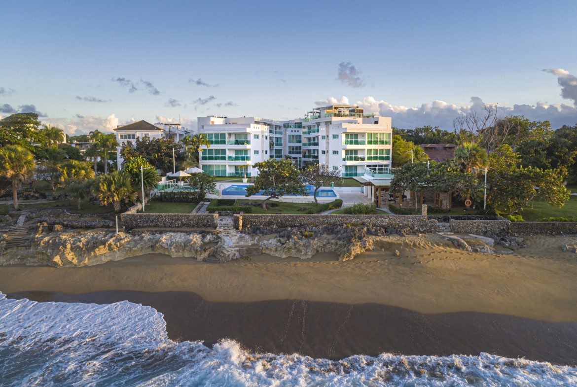 buyDRproperty Oceanfront condo for sale in Sosua with beach access and blue pool. Sosua Real Estate