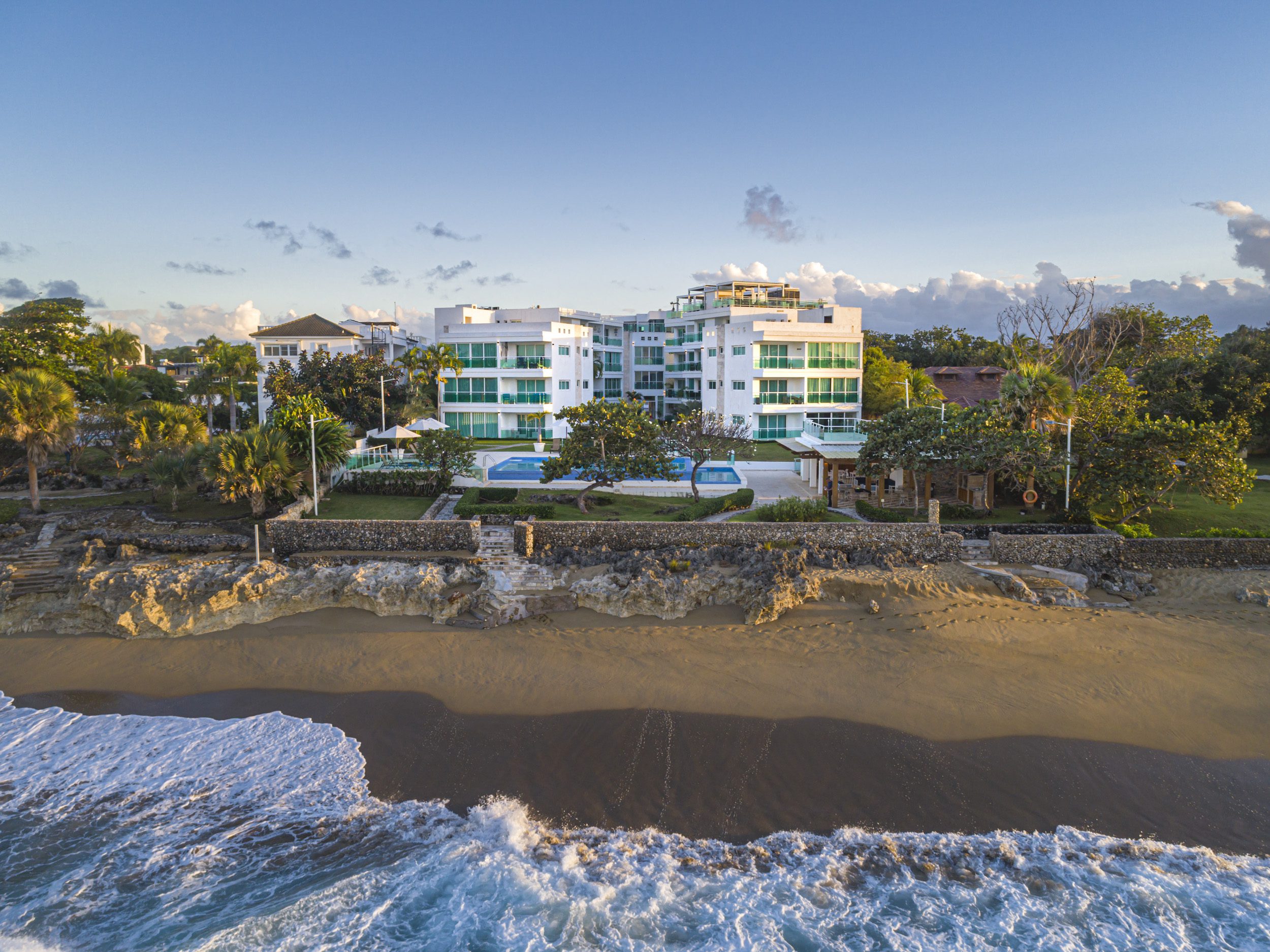 buyDRproperty Oceanfront condo for sale in Sosua with beach access and blue pool. Sosua Real Estate