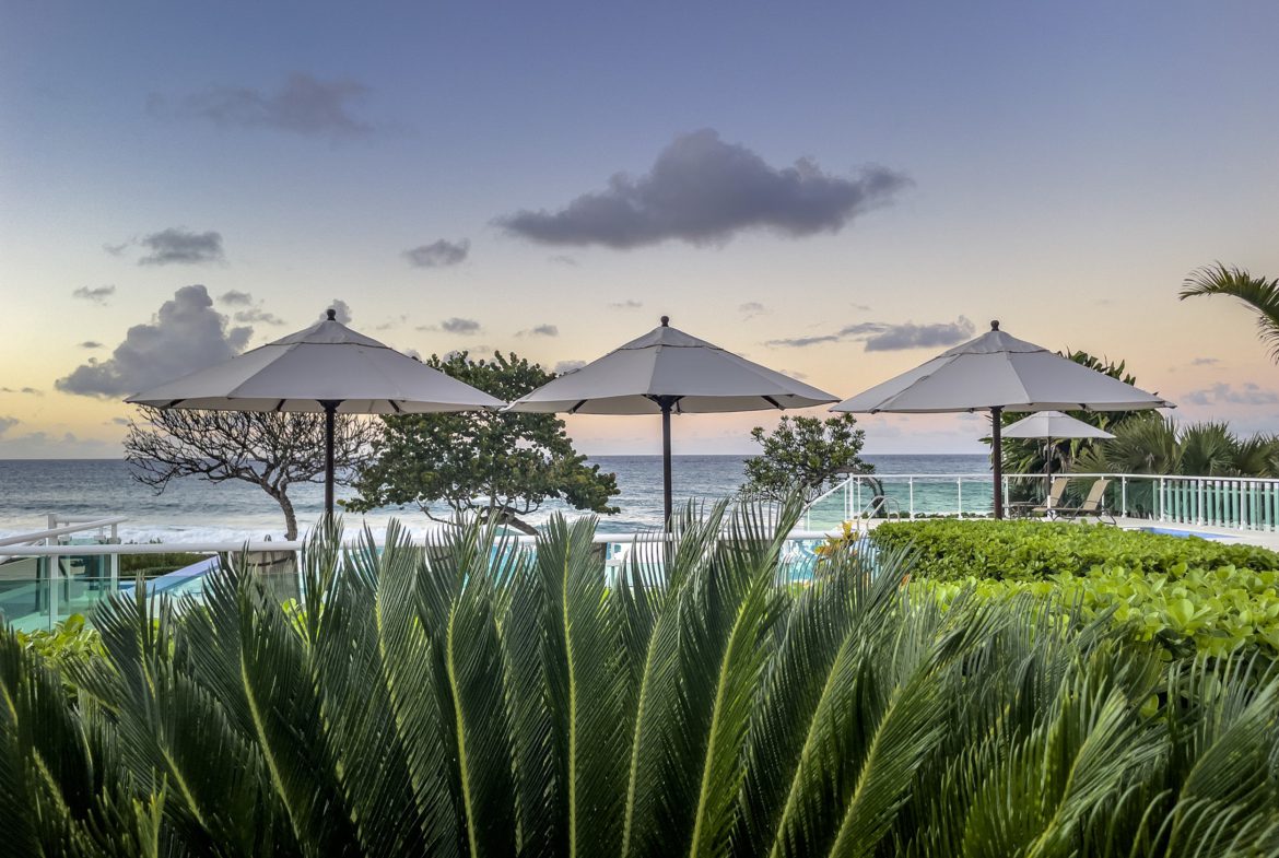 buyDRproperty Oceanfront view from a 3 bedroom oceanfront condo with beach umbrellas Sosua Real Estate