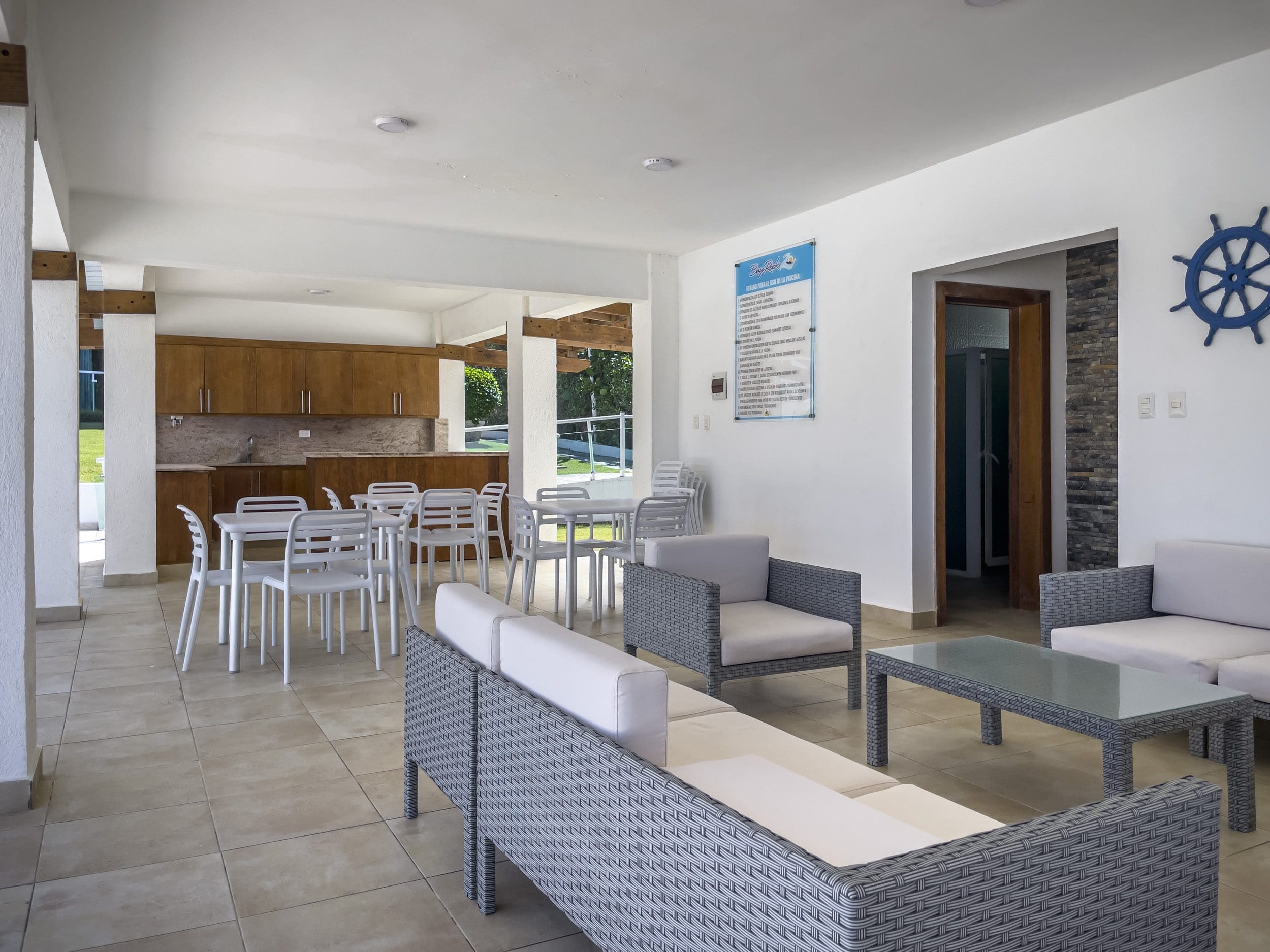 buyDRproperty Spacious common area of a 3 bedroom oceanfront condo with seating and dining areas. Sosua Real Estate