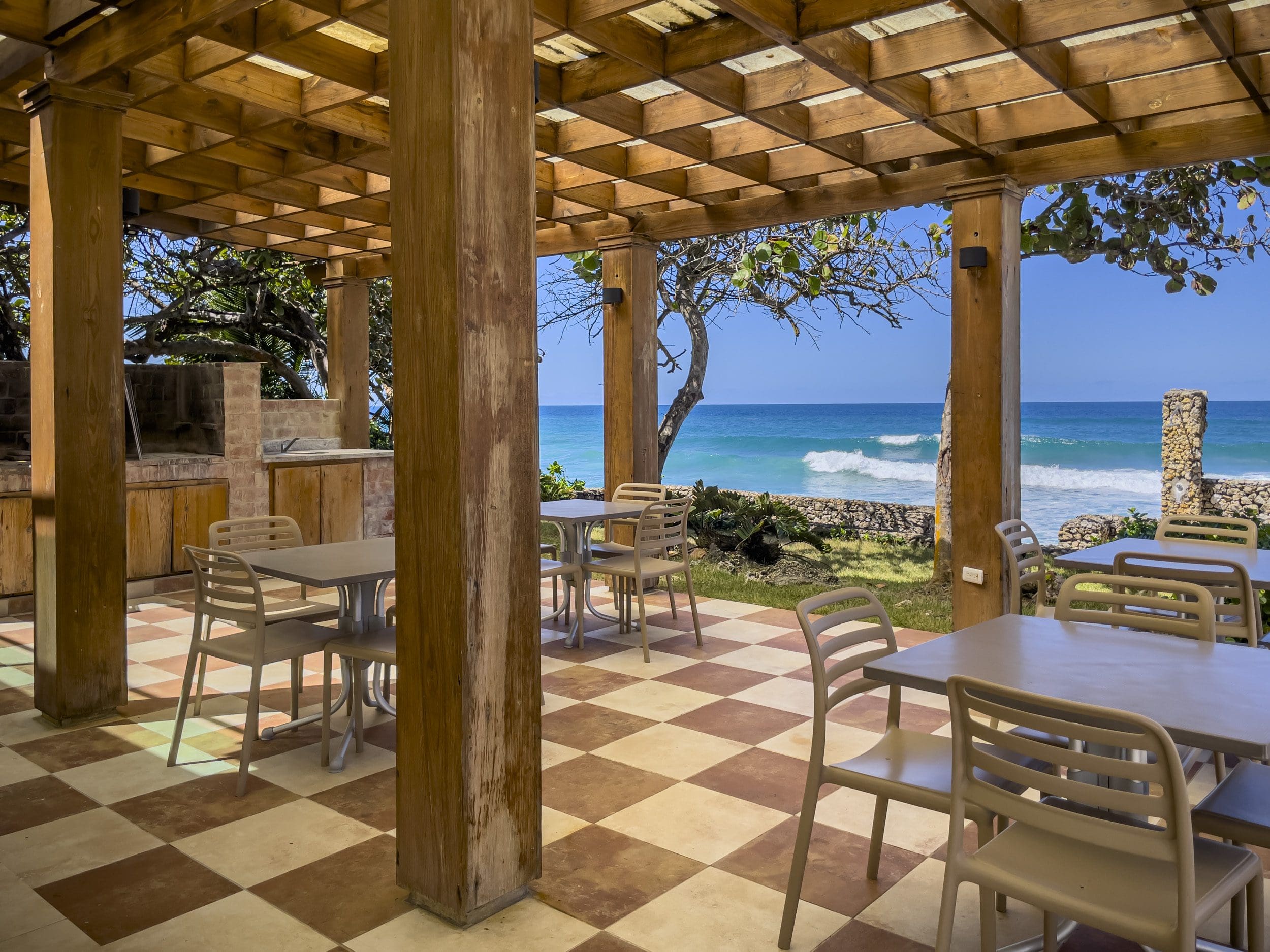 buyDRproperty Outdoor dining area of an oceanfront condo for sale, overlooking the ocean in Sosua. Sosua Real Estate