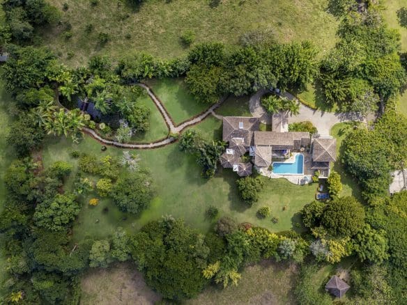 buyDRproperty Aerial view of a Beautiful 4 Bedroom Villa with a pool in a tropical setting. Haciendas el Choco Sosua Real Estate