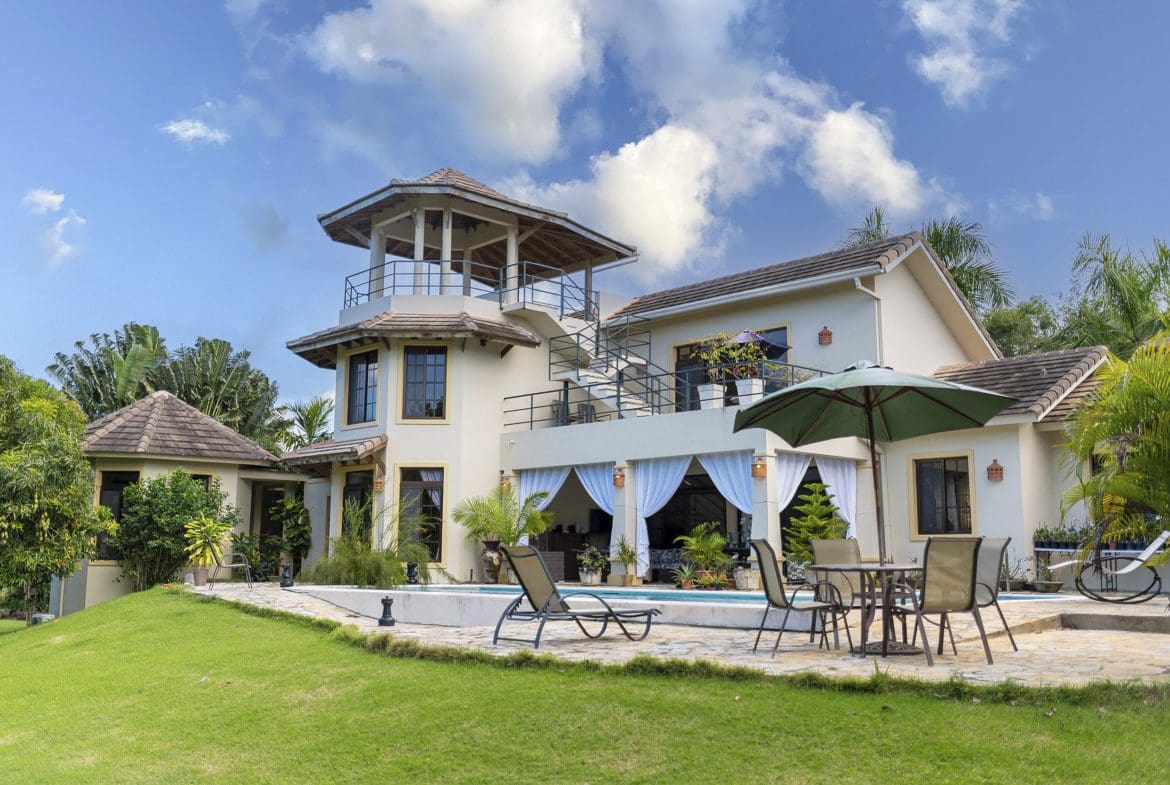 buyDRproperty Beautiful 4 Bedroom Villa for sale in Sosua, Hacienda El Choco. Luxury villa with a pool and lush landscaping. Sosua Real Estate