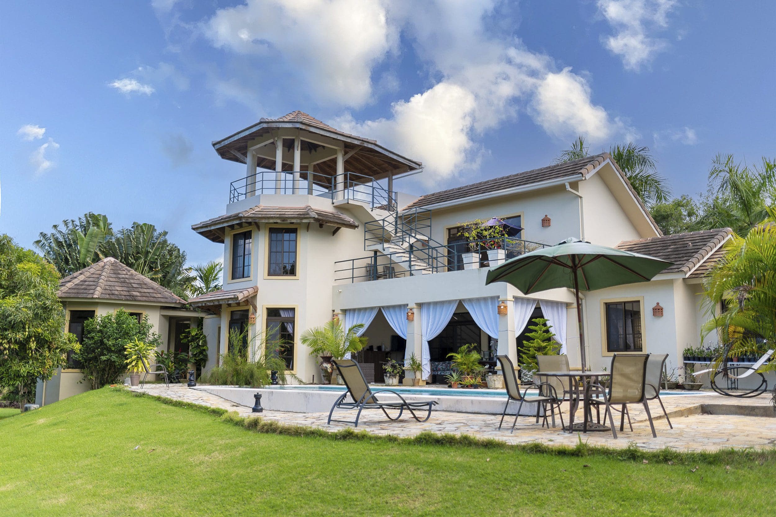 buyDRproperty Beautiful 4 Bedroom Villa for sale in Sosua, Hacienda El Choco. Luxury villa with a pool and lush landscaping. Sosua Real Estate