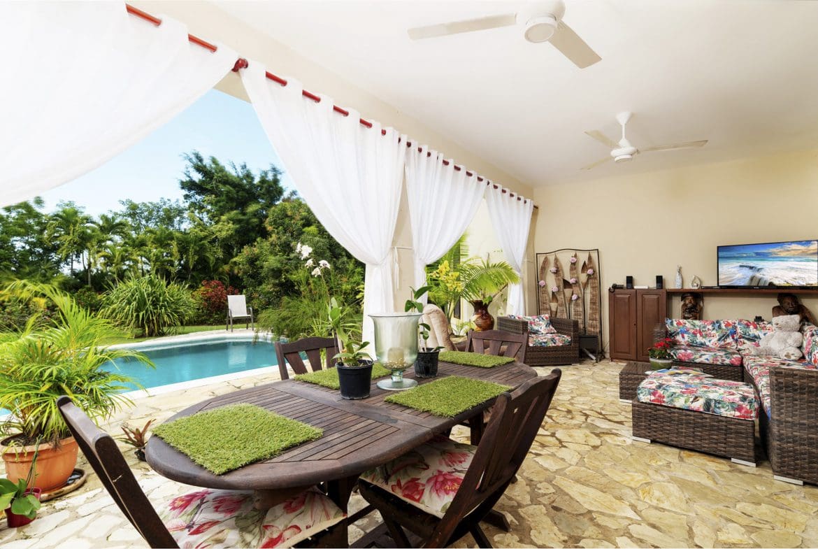 buyDRproperty Outdoor patio area of a beautiful 4 bedroom villa, overlooking the pool. Haciendas el Choco. Sosua Real Estate