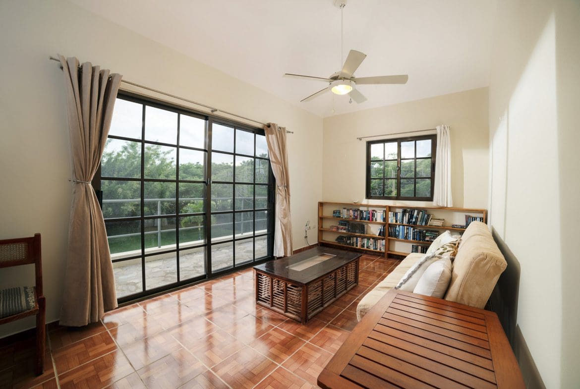 buyDRproperty Living room in Beautiful 4 Bedroom Villa with large windows and bookshelves. Sosua Real Estate