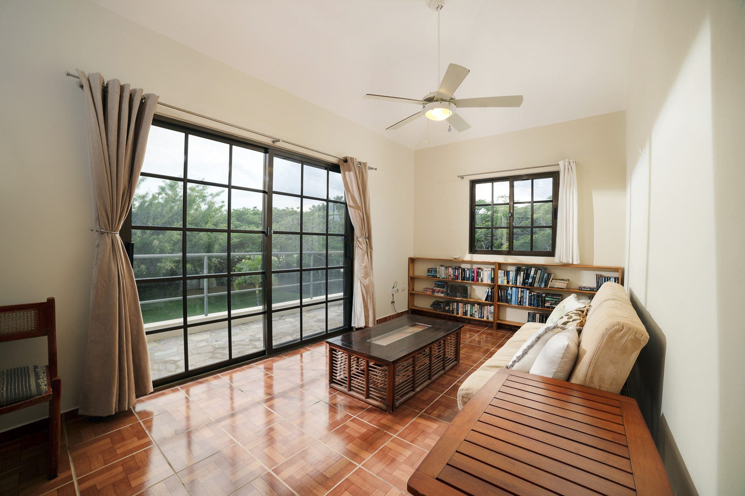 buyDRproperty Living room in Beautiful 4 Bedroom Villa with large windows and bookshelves. Sosua Real Estate