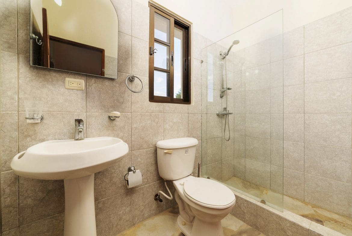 buyDRproperty Bathroom in a beautiful 4 bedroom villa in Sosua, featuring a shower, toilet, and sink. Sosua Real Estate