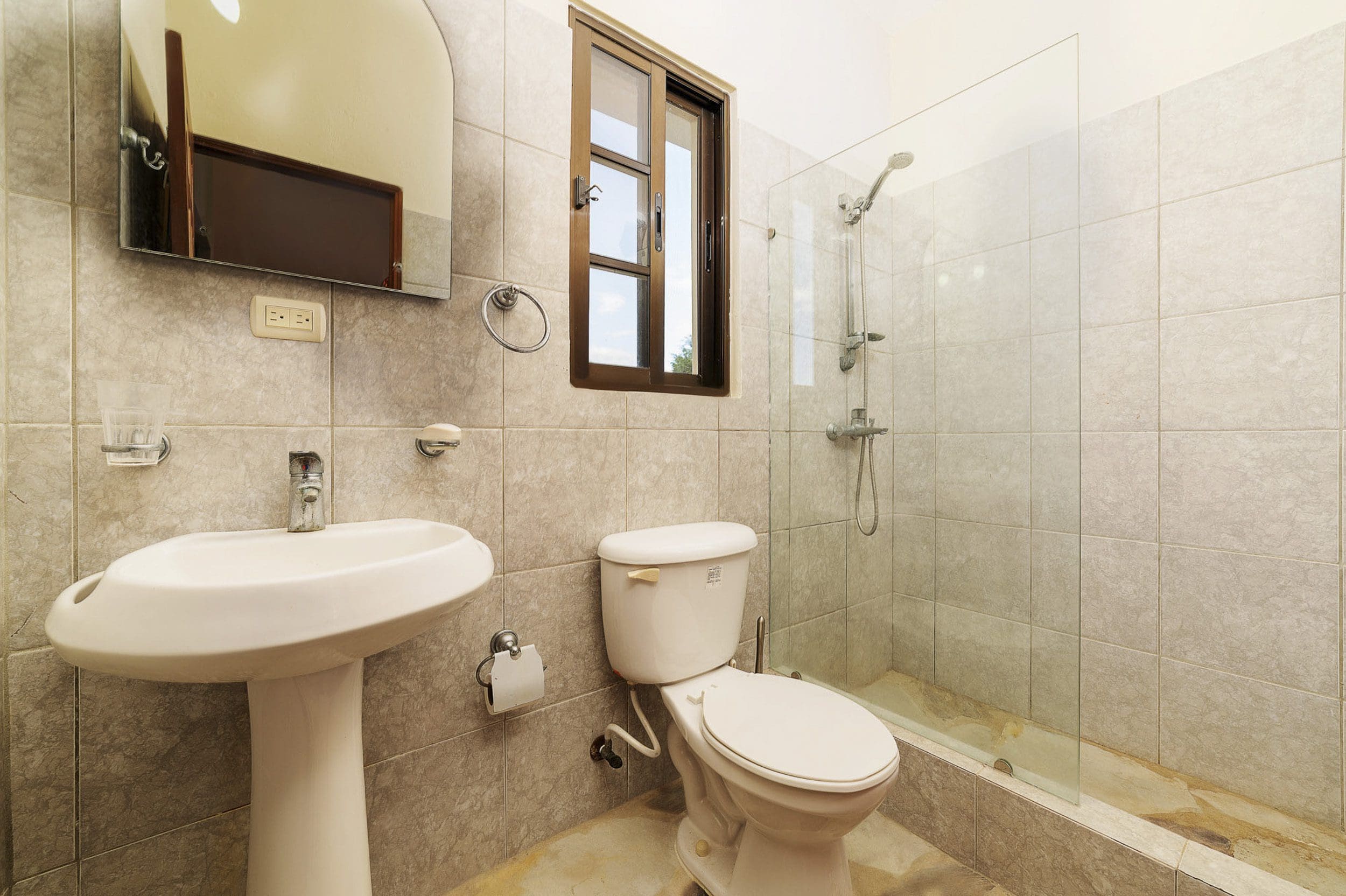 buyDRproperty Bathroom in a beautiful 4 bedroom villa in Sosua, featuring a shower, toilet, and sink. Sosua Real Estate