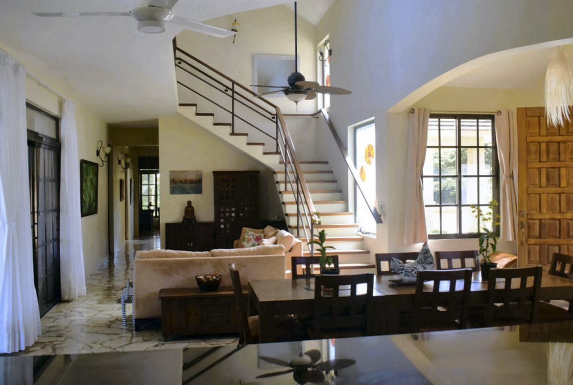 buyDRproperty Interior of a beautiful 4 bedroom villa for sale in Sosua, featuring a staircase and dining area. Sosua Real Estate