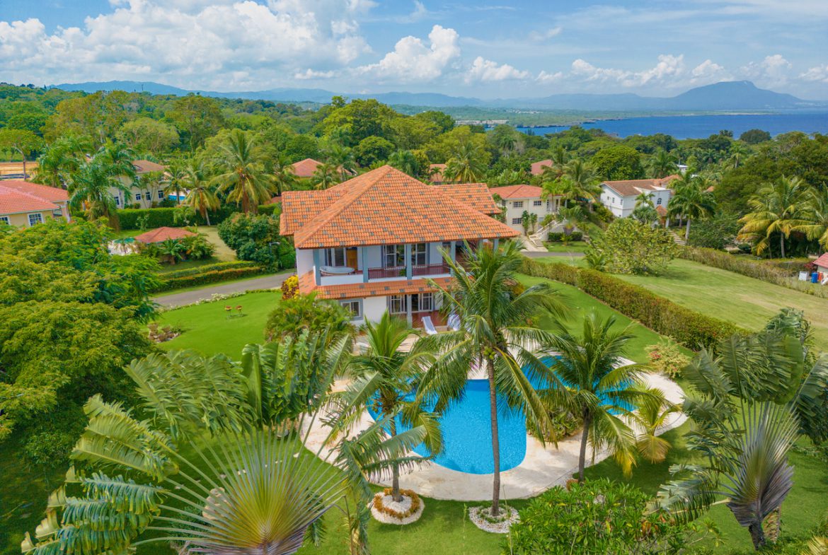 buyDRproperty Aerial view of a Beautiful 3 Bedroom Villa LOTUS in Residential Hispaniola with a pool, palm trees, and ocean view. Sosua Real Estate