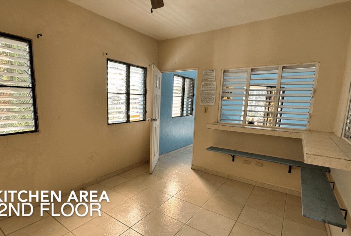 buyDRproperty Kitchen area in an Affordable Hotel Facility with tiled floors and windows. Sosua Real Estate