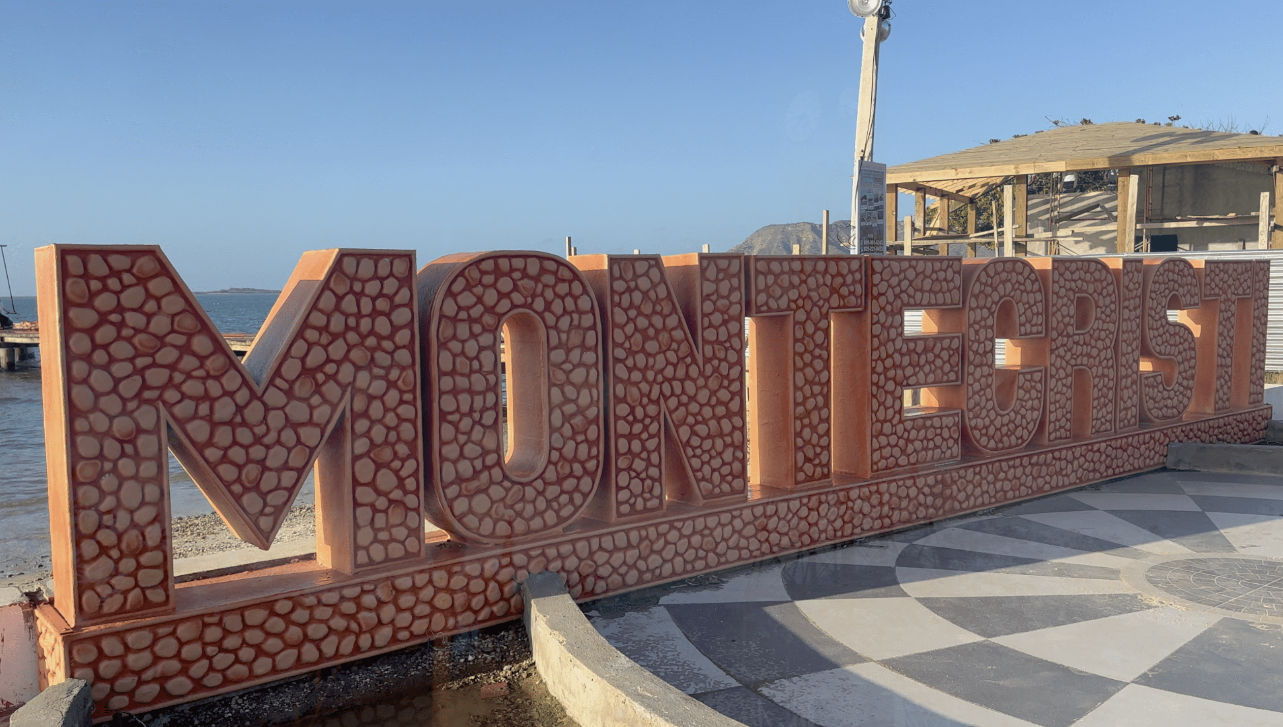buyDRproperty Colorful Monti Cristi sign by the ocean, highlighting local attractions Sosua Real Estate
