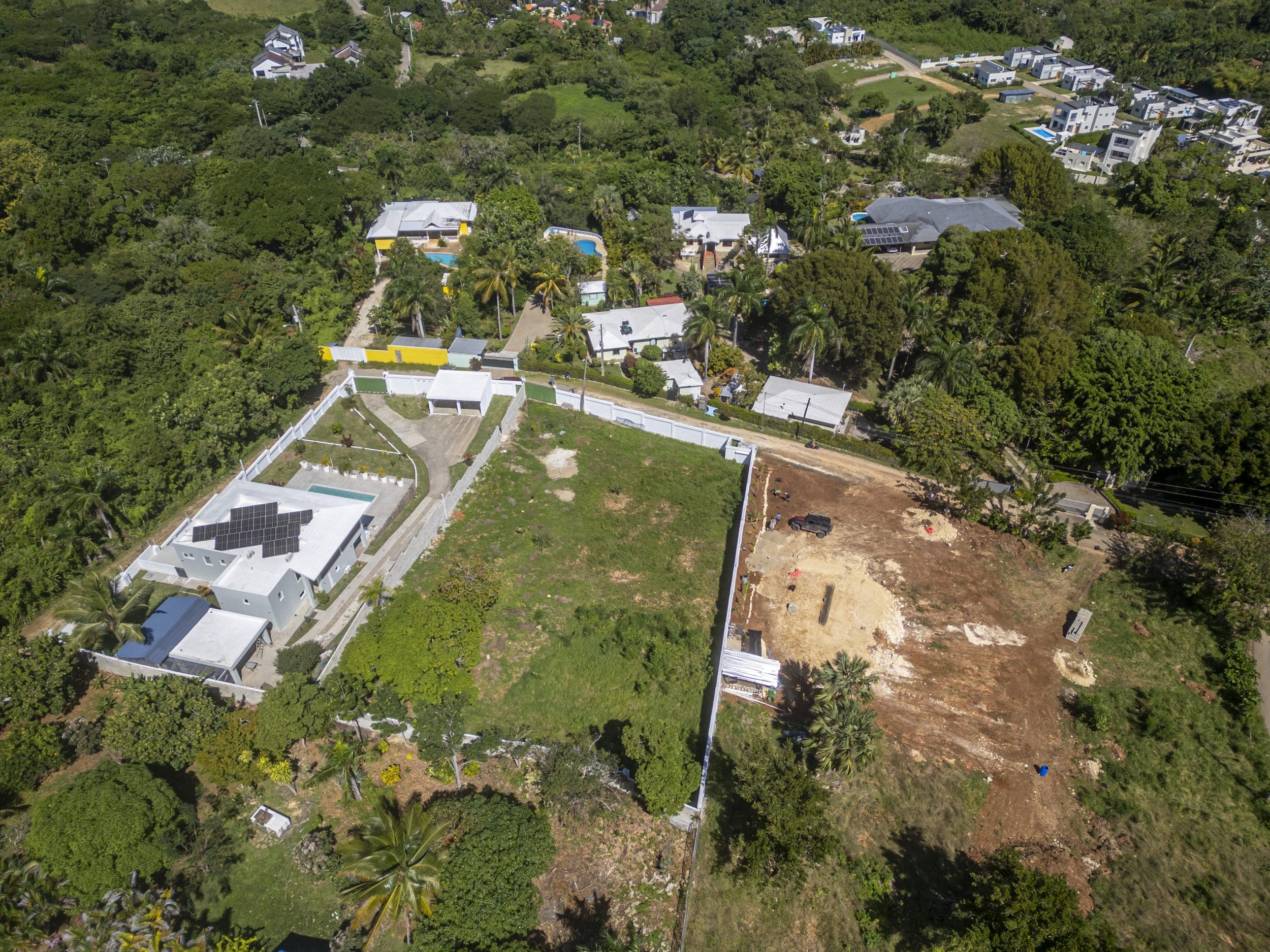 buyDRproperty Aerial view of lots for sale in La Mulata with houses and green vegetation Sosua Real Estate