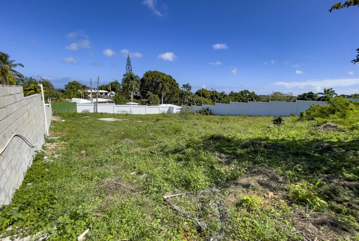 buyDRproperty Vacant lot for sale in La Mulata with white wall and blue sky. Sosua Real Estate