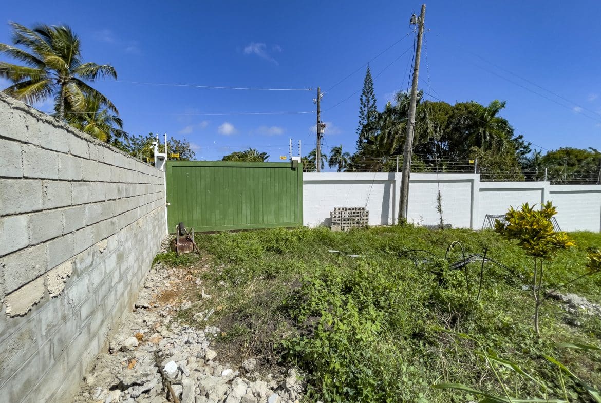 buyDRproperty Property with a wall and green gate; lots for sale. Sosua Real Estate