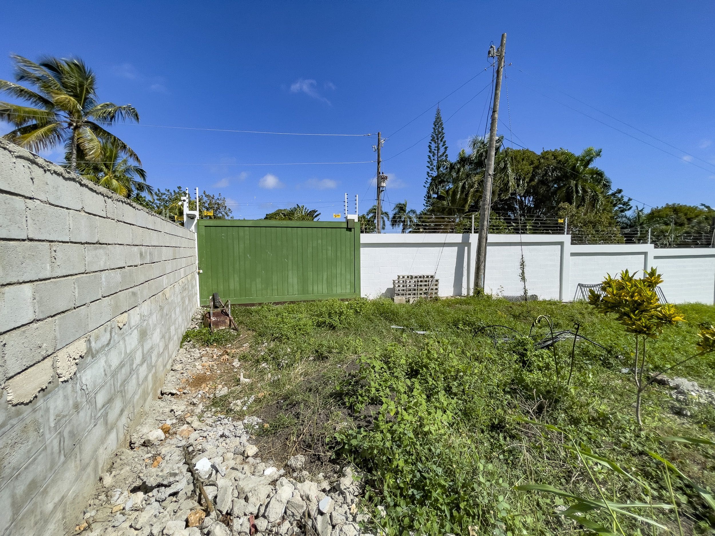 buyDRproperty Property with a wall and green gate; lots for sale. Sosua Real Estate