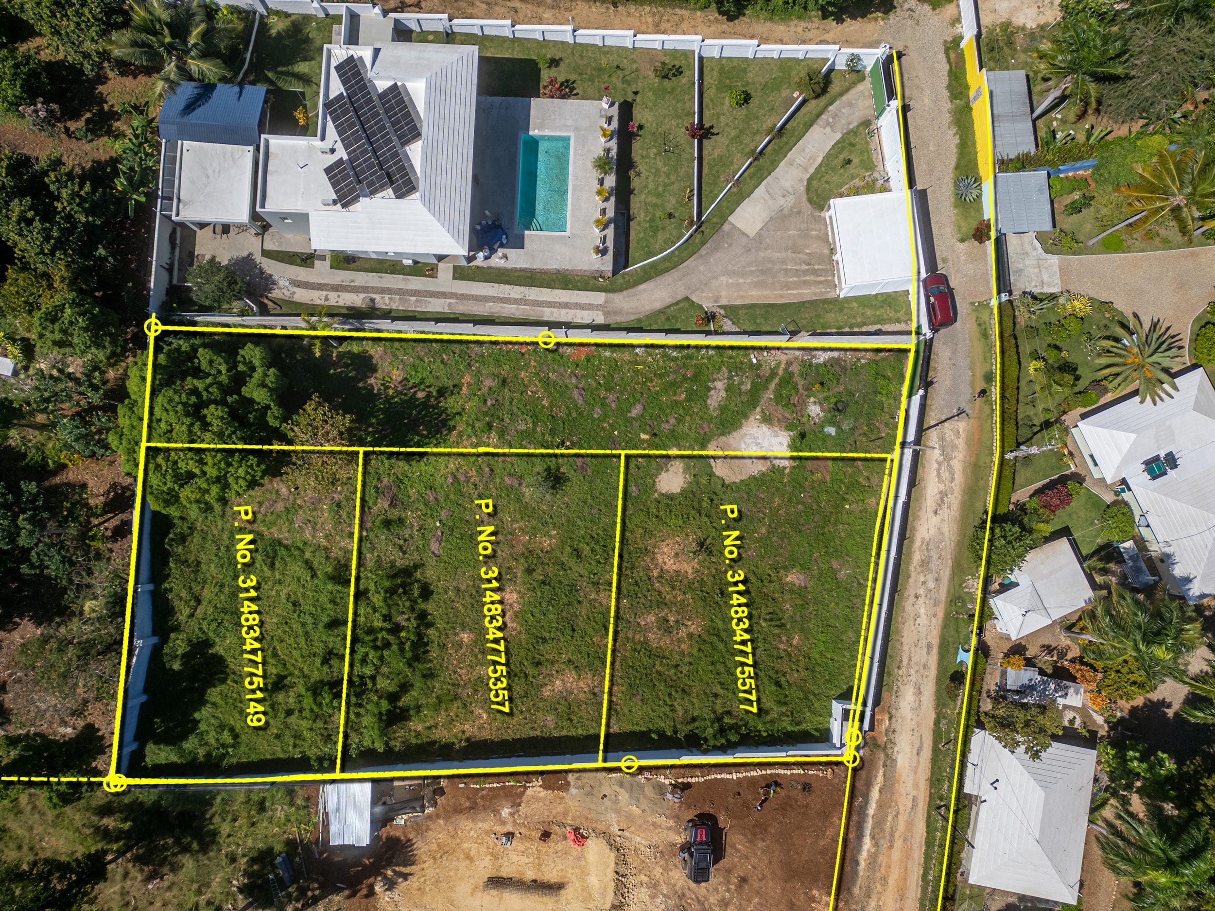buyDRproperty Aerial view of lots for sale in La Mulata, featuring property lines and surrounding homes. Sosua Real Estate