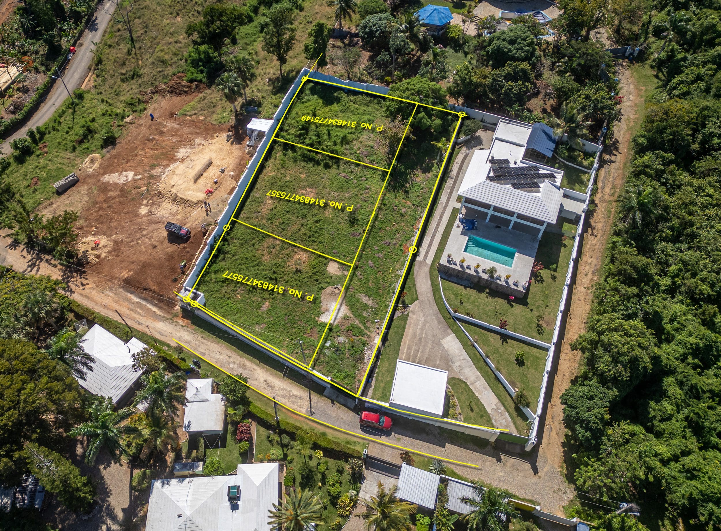 buyDRproperty Aerial view of lots for sale in La Mulata, featuring marked land parcels and a house with a pool. Sosua Real Estate