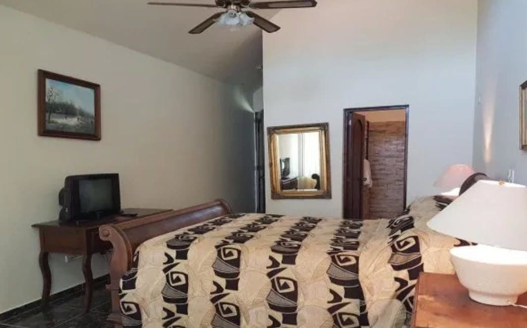 buyDRproperty Hotel room with a bed and a TV. Hotel Near The Beach Sosua Real Estate