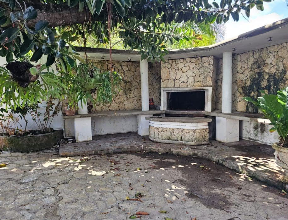 buyDRproperty Outdoor kitchen area at a hotel near the beach, with stone construction and plants. Sosua Real Estate
