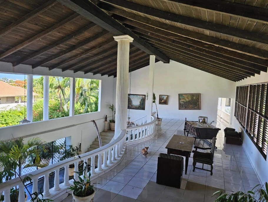 buyDRproperty Interior view of a Hotel Near The Beach with a high ceiling and balcony. Sosua Real Estate