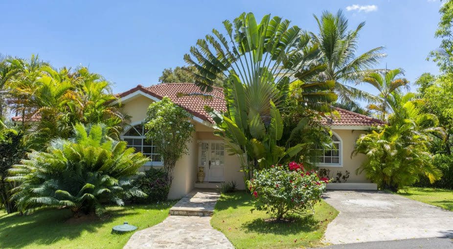 buyDRproperty Exterior view of a Wonderful 3 Bedroom Villa with lush tropical landscaping. Sosua Real Estate
