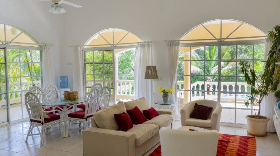 buyDRproperty Living room of a Wonderful 3 Bedroom Villa with arched windows and outdoor views. Sosua Real Estate
